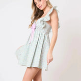 Women's charming green mini dress with bow and ruffles.